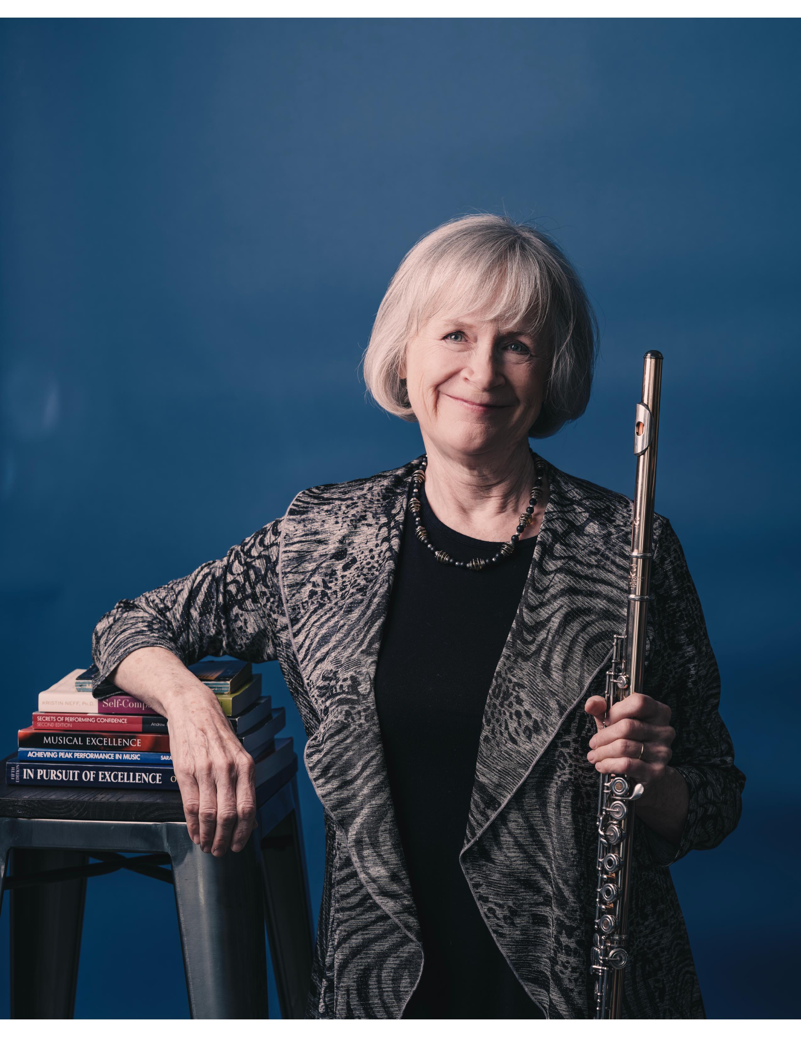 Christie Headshot with books and flute